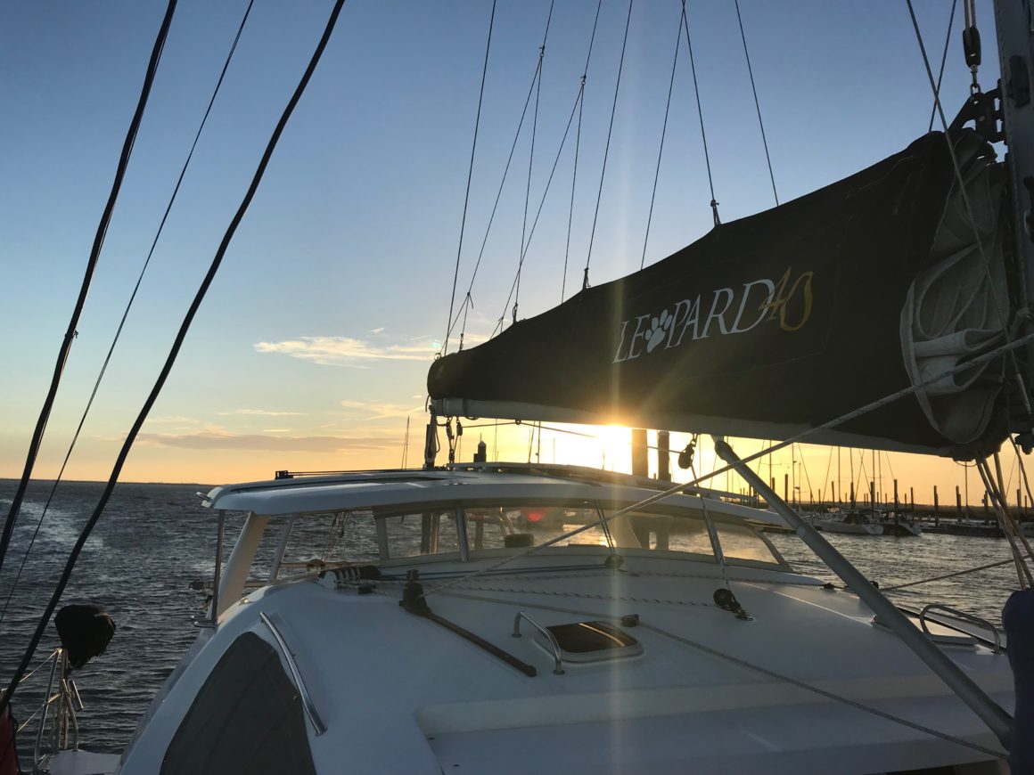 Sunset shining through the main sail on our Leopard 40