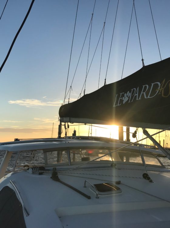 Sunset shining through the main sail on our Leopard 40